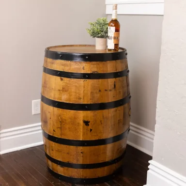 Whiskey barrel with black rings and bottle on top