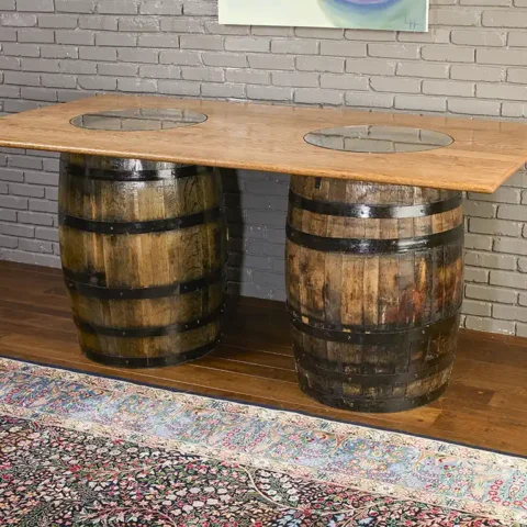 2 whiskey barrel table with a solid oak top and 2 glass inserts to show the distillery stamps on the barrels.