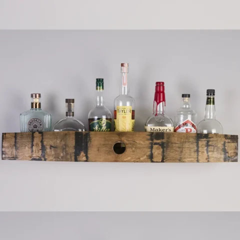 Whiskey barrel stave shelf with bottles of bourbon on it