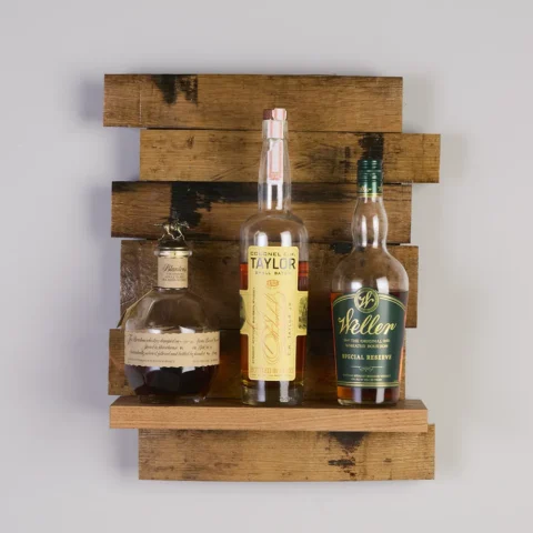 Small staggered stave shelf with 3 bottles of bourbon on the shelf