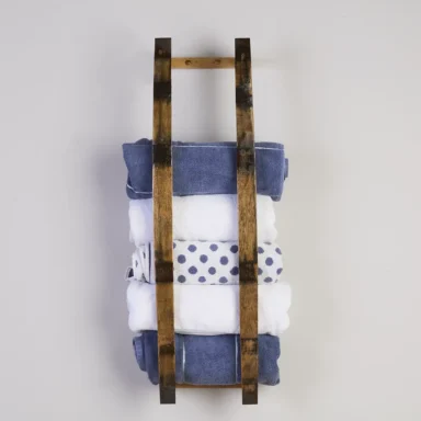 Barrel stave towel rack holding multiple rolled bath towels